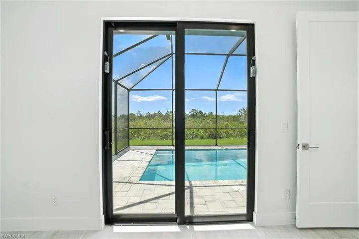 Doorway with a sunroom and baseboards
