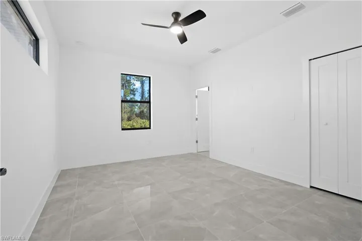 Unfurnished bedroom featuring ceiling fan and a closet
