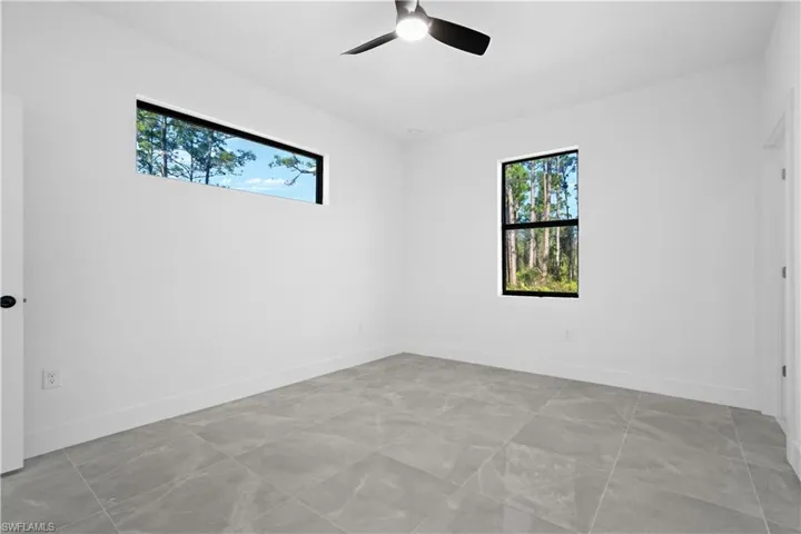 Unfurnished room featuring baseboards and ceiling fan
