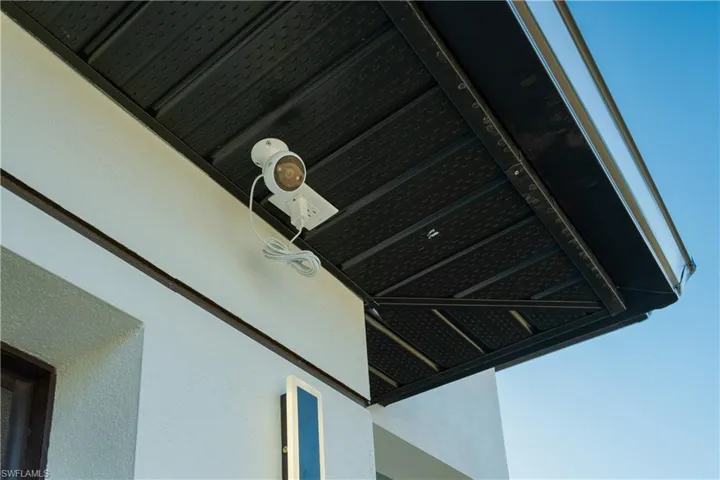 Detailed view of a surveillance system and stucco siding
