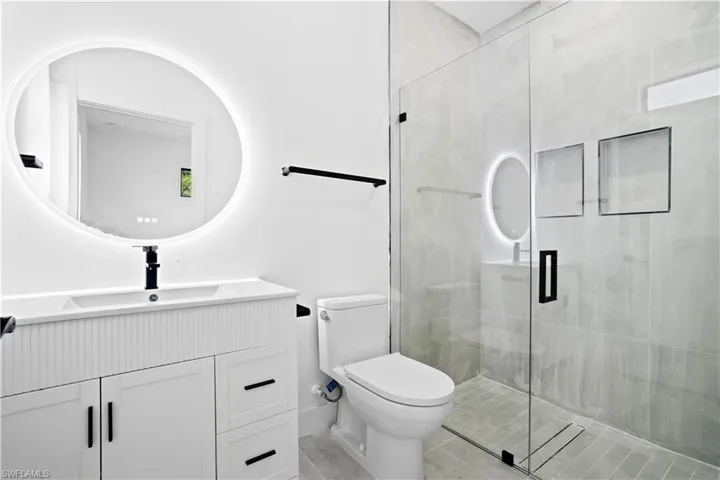Full bath featuring vanity and a shower stall