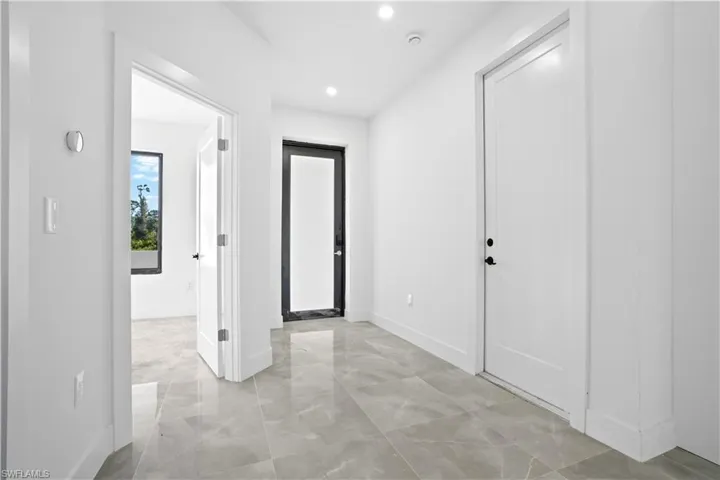 Entrance foyer featuring baseboards and recessed lighting