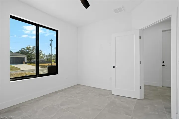Unfurnished room featuring a ceiling fan and baseboards