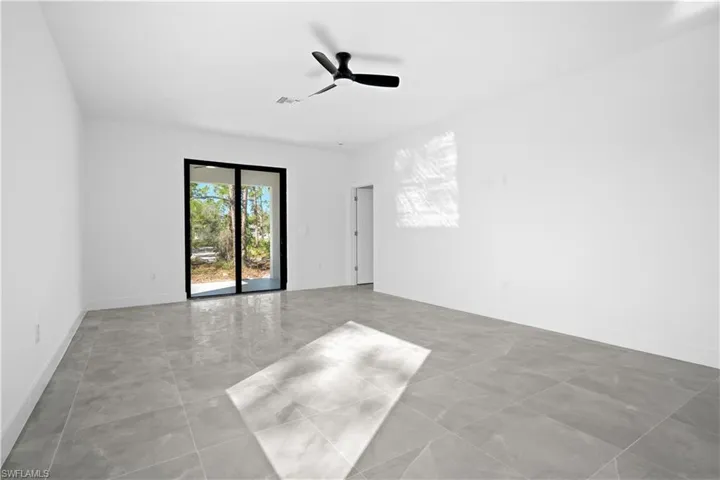 Empty room featuring a ceiling fan and baseboards