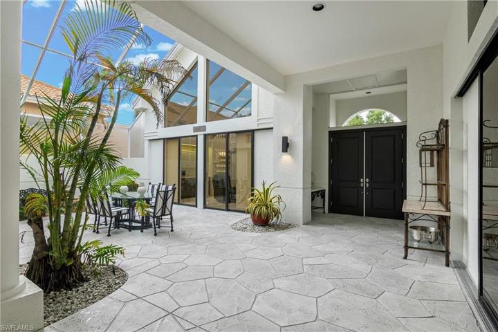 Lanai adjoining guest house & main house makes for a grand entrance