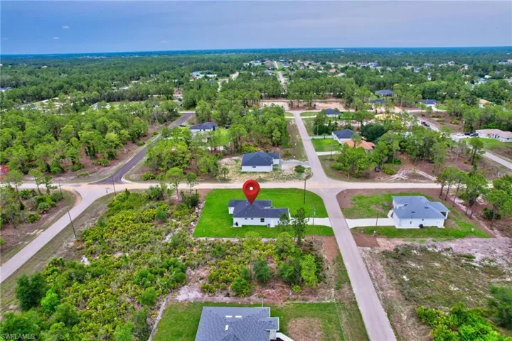 Aerial view of property's location with nearby suburban area