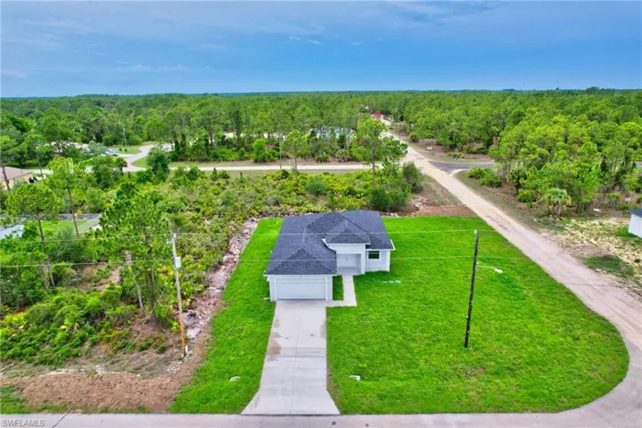 View from above of property featuring a heavily wooded area