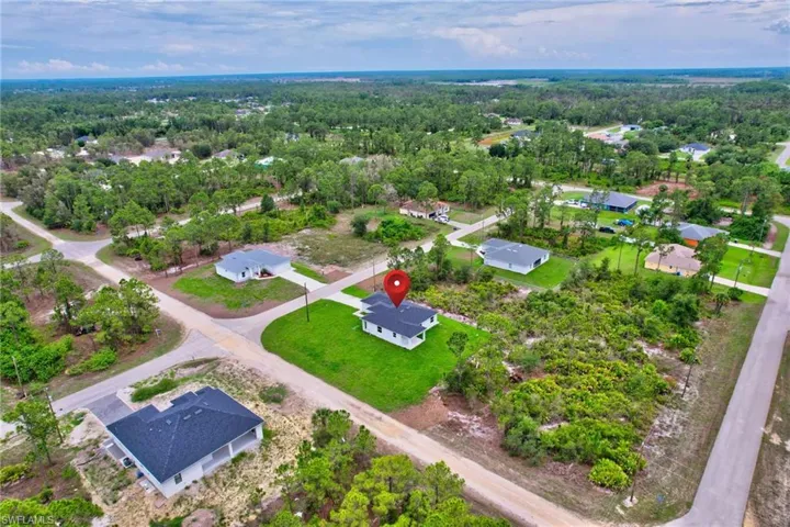 Aerial view of residential area featuring a heavily wooded area