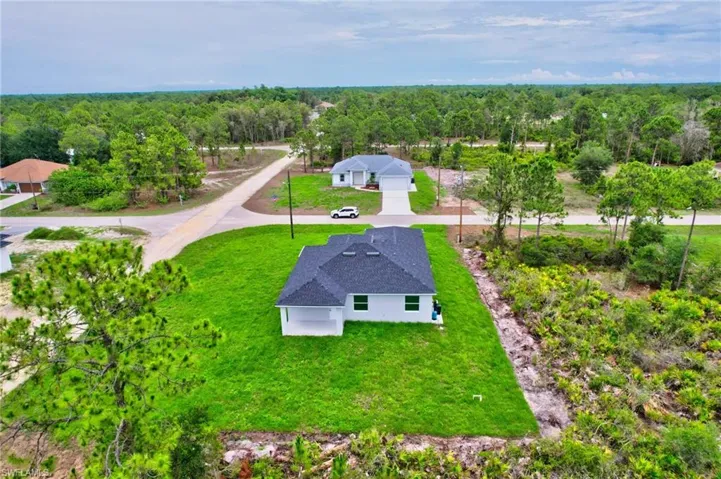 View from above of property featuring a heavily wooded area
