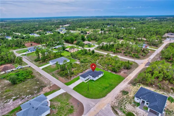 Aerial view of residential area with a heavily wooded area