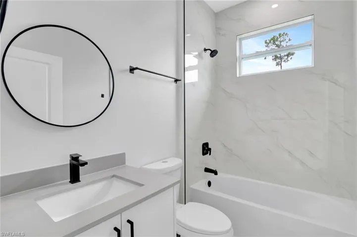 Full bath with toilet, vanity, and  shower combination