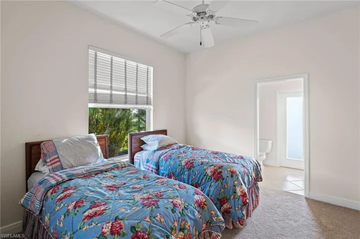Bedroom featuring light colored carpet and ceiling fan