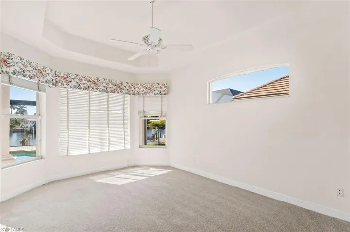 Empty room featuring carpet and ceiling fan