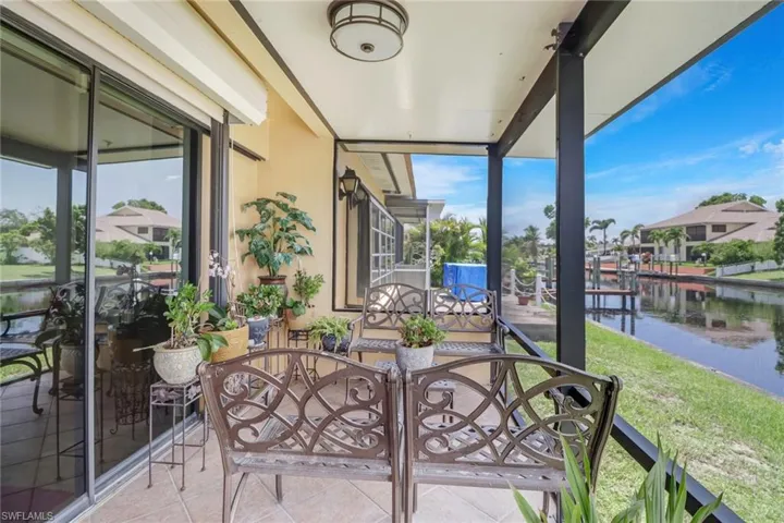 Sunroom / solarium with a water view and plenty of natural light