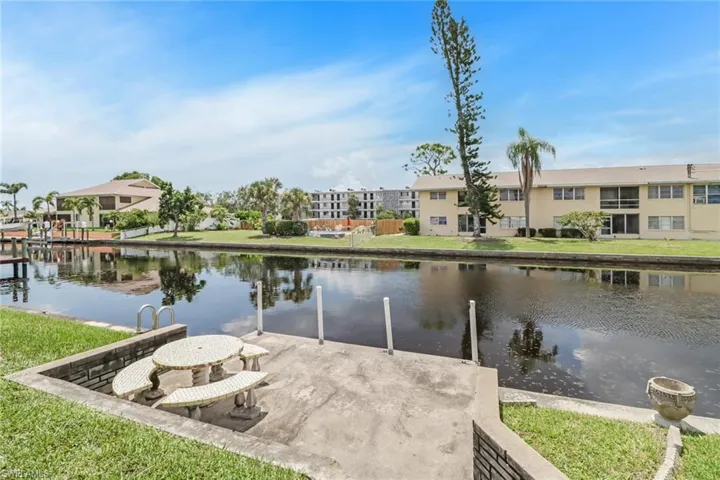 Dock area featuring a lawn and a water view