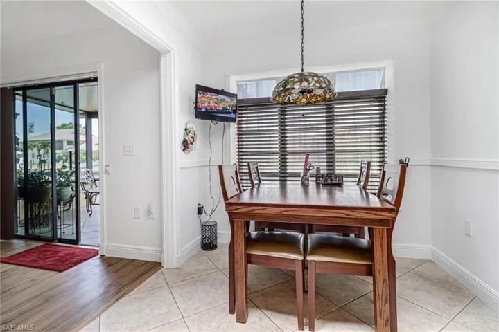 Dining area with crown molding and light hardwood / wood-style floors