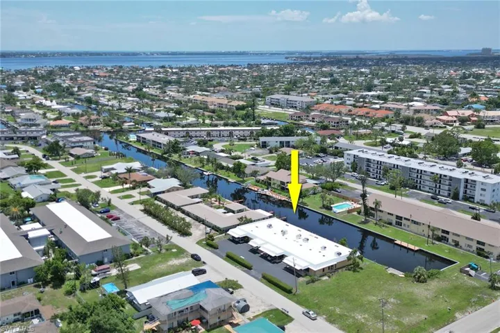 Birds eye view of property with a water view