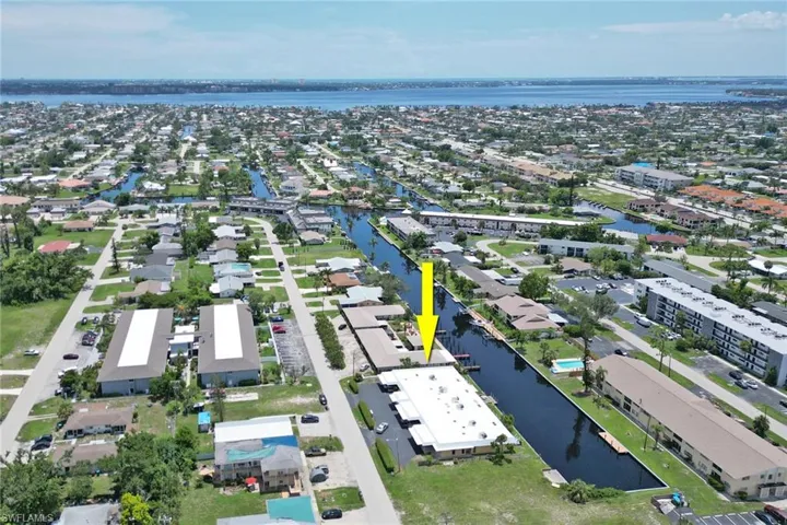 Birds eye view of property with a water view