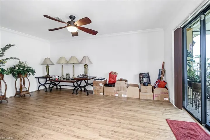 Misc room with light hardwood / wood-style floors, ceiling fan, and crown molding