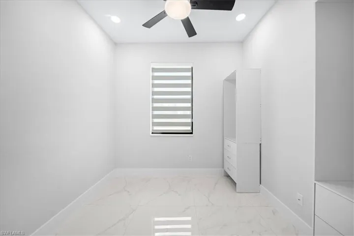 Unfurnished bedroom featuring recessed lighting, light marble finish floors, and ceiling fan