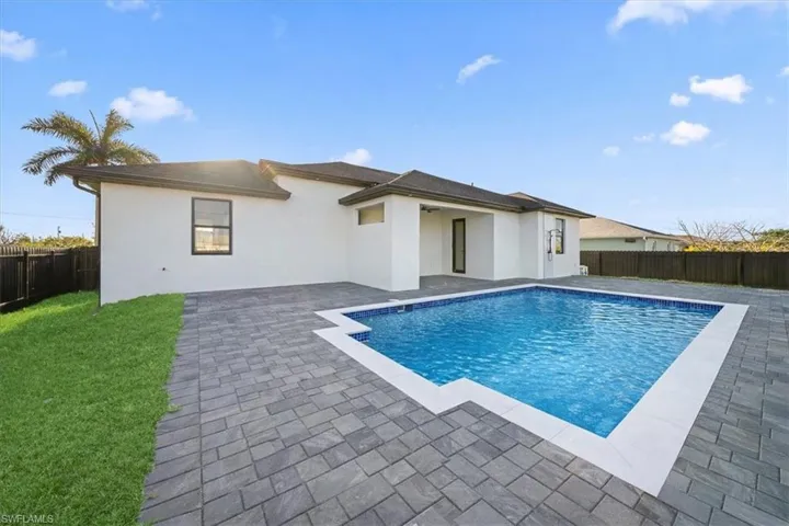 Back of house with a fenced backyard, a patio, and stucco siding