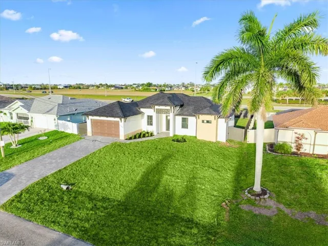 View of front of house featuring decorative driveway, an attached garage, stucco siding, and a residential view
