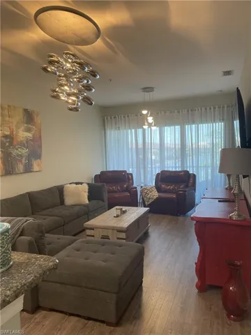 Living room with hardwood / wood-style floors and a chandelier