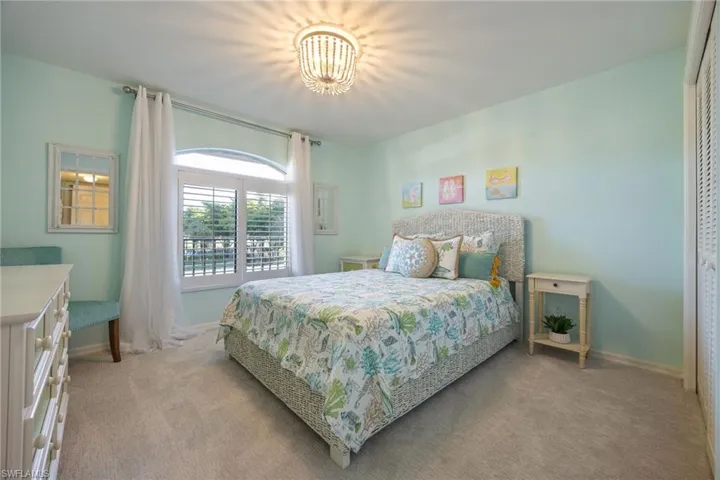Guest Bedroom featuring New carpet flooring and plantation shutters on window, new light fixture.