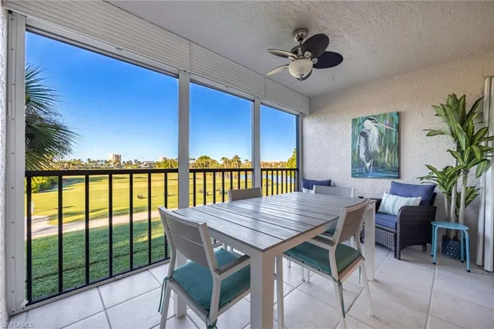 Screened in lanai with ceiling fan, view of golf course and lake.  Great spot to view sunrise & sunsets!