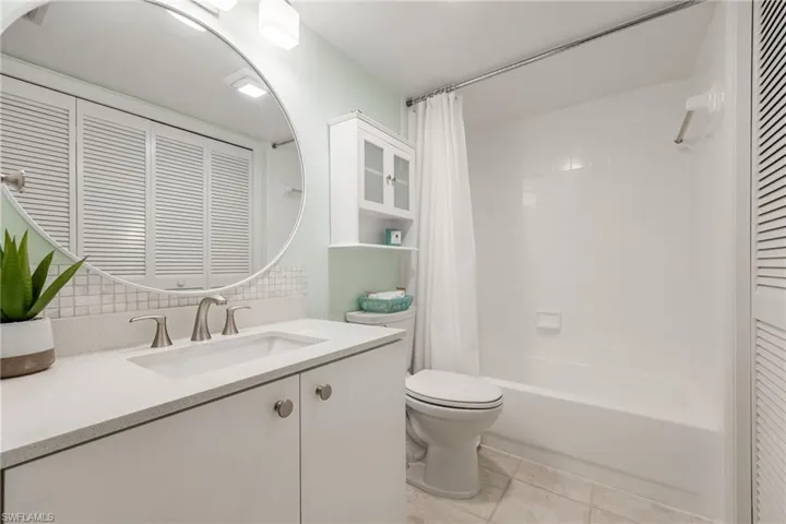 Full Guest bathroom featuring shower/tub combo with new vanity, and light fixture.