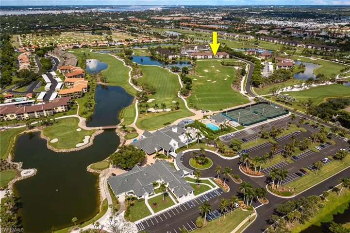 Aerial view of property's location featuring a large body of water and nearby suburban area