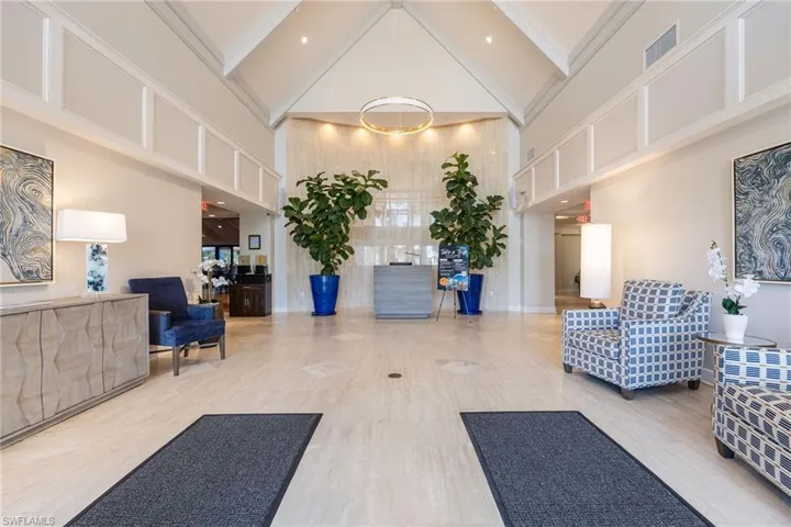 Lobby with high vaulted ceiling and beamed ceiling