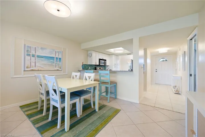 Living area featuring light tile on diagonal, new neutral painted walls.