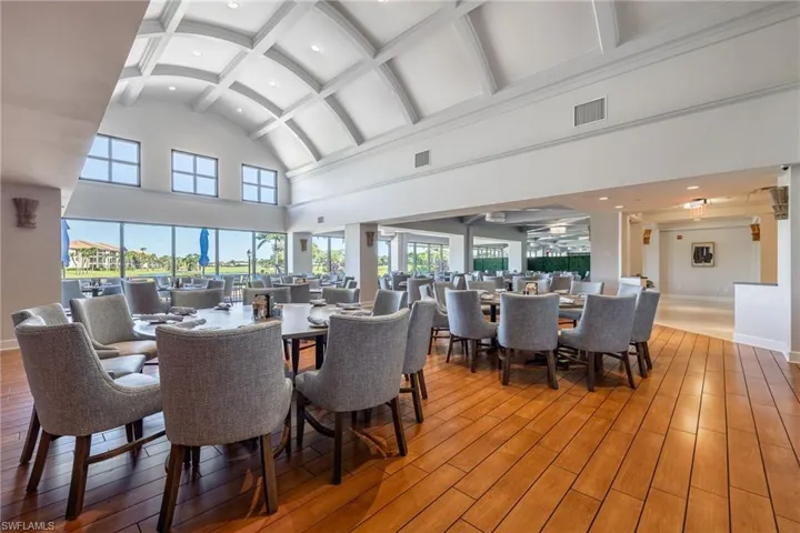 Dining area featuring beamed ceiling, wood-type flooring, high vaulted ceiling, and recessed lighting