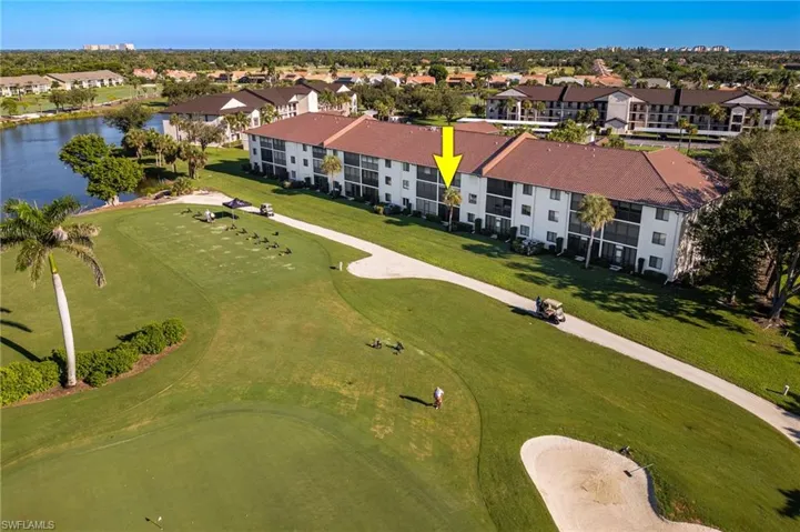 Drone / aerial view of a golf club and a nearby body of water