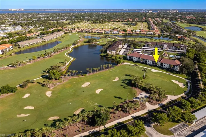 Aerial overview of property's location with a local golf course, a large body of water, and nearby suburban area