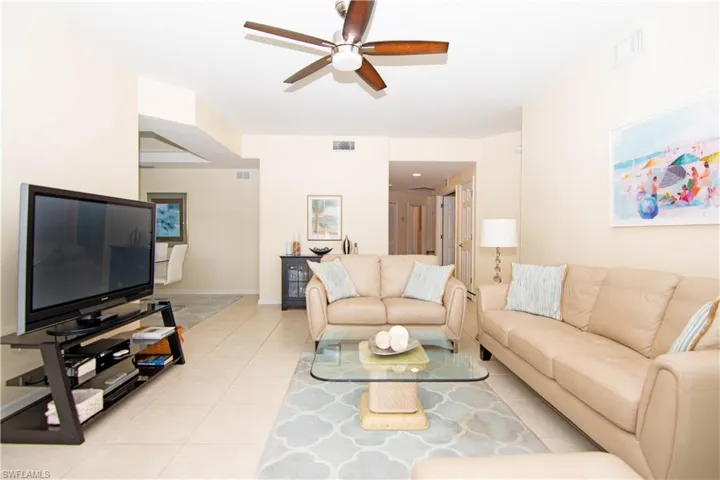 Spacious living room tastefully appointed with leather furnishings.
