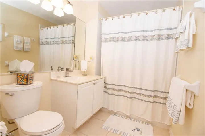 Guest bath offers tiled shower and tub.