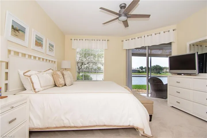 Primary bedroom suite offers a peaceful sanctuary with sliding glass doors to your screened lanai.