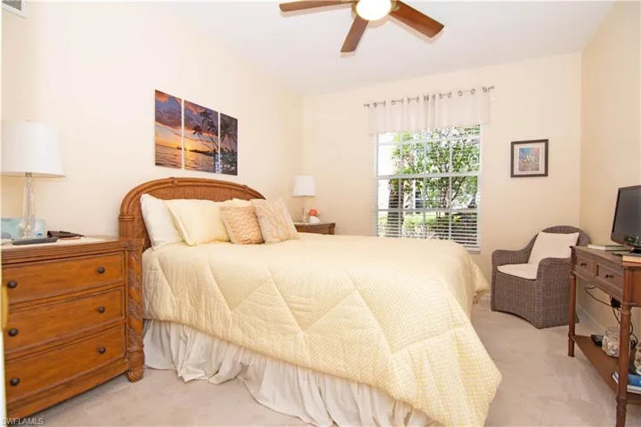 Spacious guest bedroom offers a queen sized bed and adjacent bath.