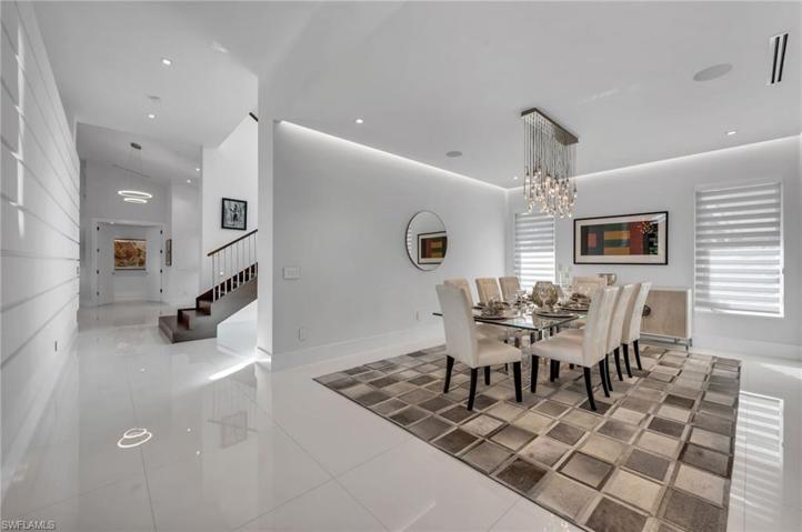 Enjoy family dinners in this fabulous dining room, framed by a gorgeous, custom light fixture and fabulous RH rug.