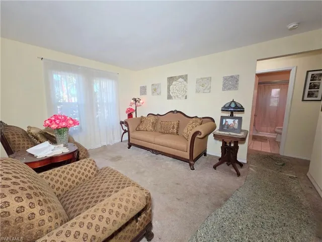 Living room with carpet flooring and baseboards