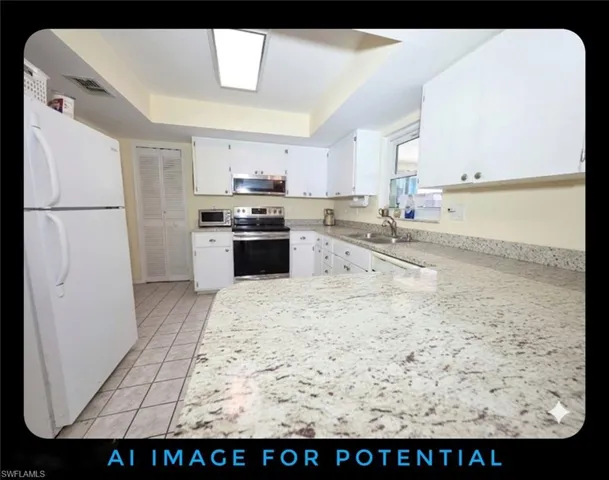 Kitchen featuring stainless steel appliances, a raised ceiling, a peninsula, white cabinetry, and light tile patterned floors