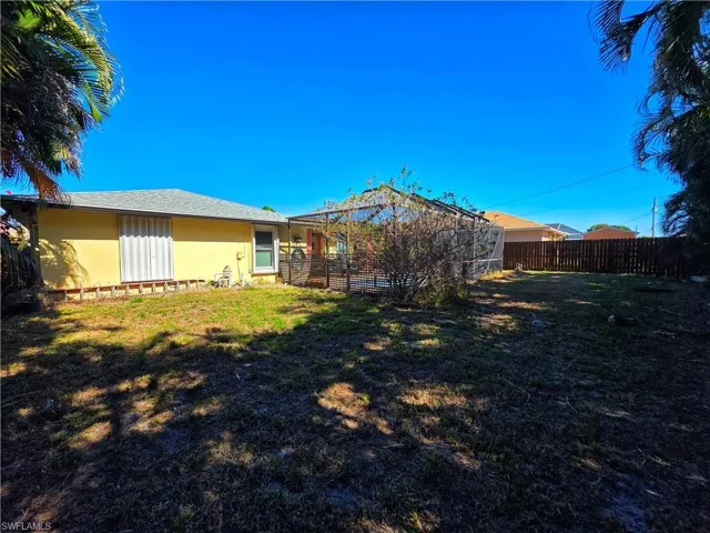 Back of house featuring a fenced backyard and stucco siding