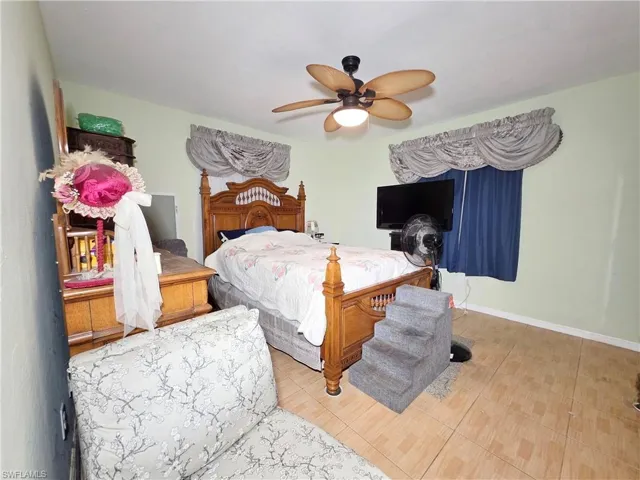 Bedroom with a ceiling fan and baseboards