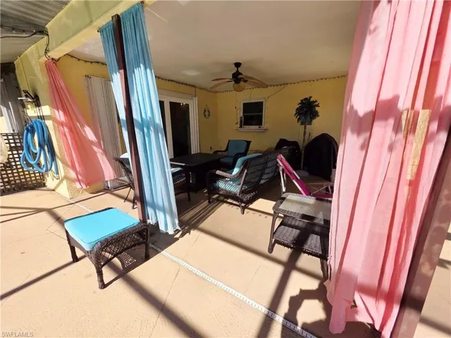 View of patio featuring outdoor lounge area and a ceiling fan