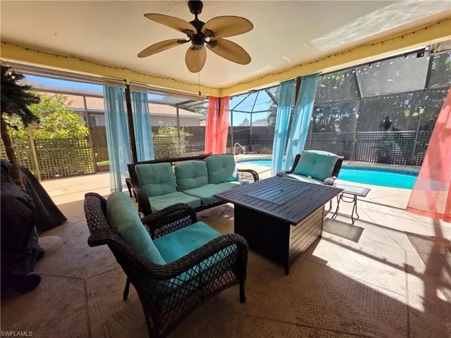 View of patio / terrace with a lanai, outdoor lounge area, a sunroom, and a ceiling fan