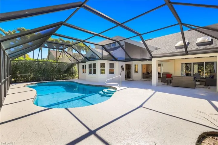 Screened pool and lanai with expansive patio and outdoor living space.