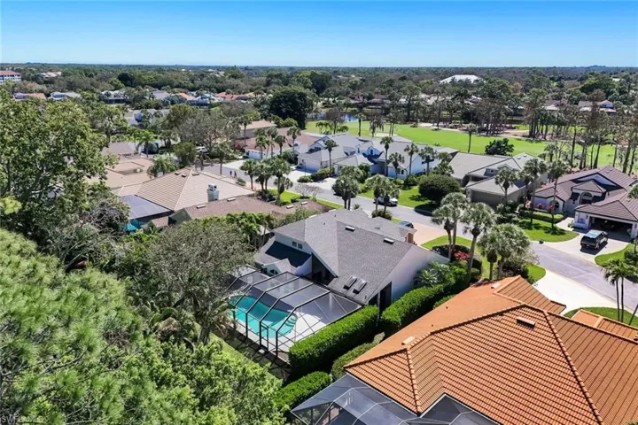 Aerial view of home and surrounding golf course community.