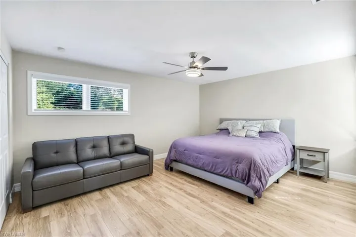Oversized second bedroom featuring tile flooring and ceiling fan.